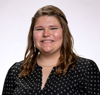 Headshot of Zoey Haugen, a female student with long brown hair wearing a black and white polka dot blouse