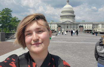 student in front of capitol building