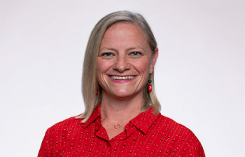 Headshot of Amy Lloyd, a woman with short blonde hair wearing a red button up.