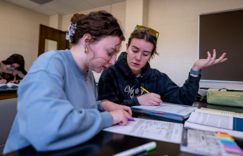 Two female students work on an exercise during class