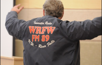 A former WRFW radio student shows off their jacket during the 40th anniversary banquet