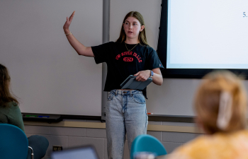 A female student give a presentation during class