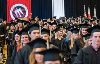 Graduating students walking during commencement