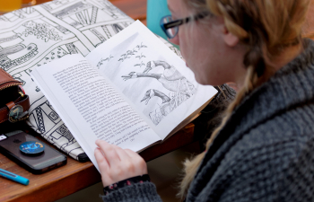 A female student reads a book during class