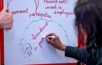 A female student writes on a portable whiteboard