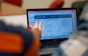 A student helps another student with math homework