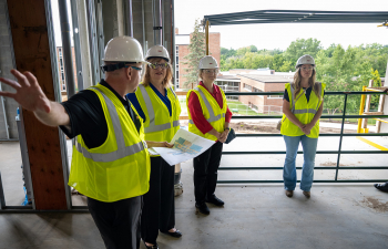 A hard hat tour goes through the SciTech construction project