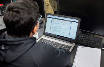 Looking over a student's shoulder at their open laptop screen