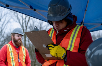 A student uses a clipboard to write data