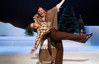 Two theater members perform on stage