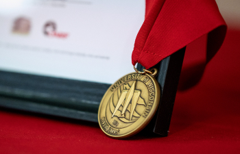 A medallion placed on an award in a frame