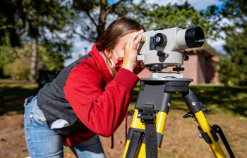 Environmental Engineering student using surveying equipment during class