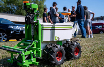 Agriculture students stand next to a piece of precision agriculture machine