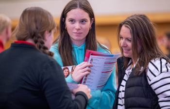 A future student listens to a staff member during campus close up