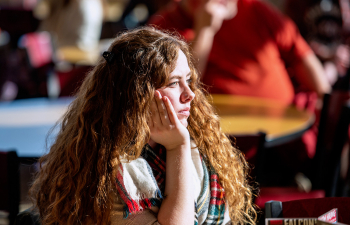 A female student listens to a speaker in the University Center