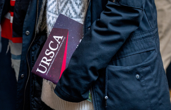 A person holds an URSCA fall gala booklet