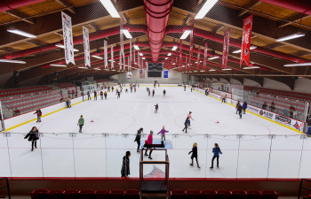 A group of people enjoy an open skate session in Hunt Arena
