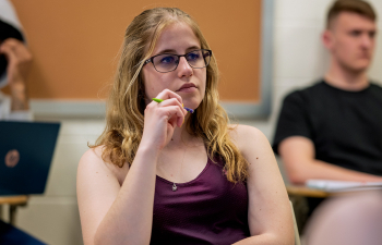 A student listens to a professor during class