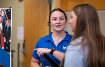 A female employer from TurnKey talks to a student during the Career Fair