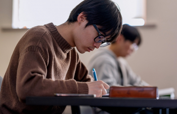 A student takes notes during class