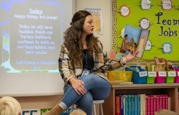 A teacher reads to a classroom