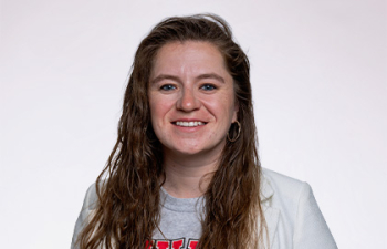Headshot of Deanna Cahoon-Draus, a young woman with long brown hear wearing a gray UWRF sweatshirt