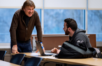 An engineering professor speaks to a student on their laptop