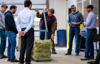 A professor examines a students senior design project