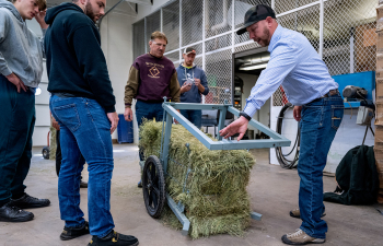 A professor examines a students senior design project