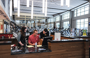 Student employees work the membership desk at the Falcon Center