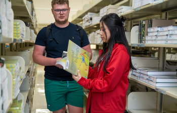 Students looking at textbooks.