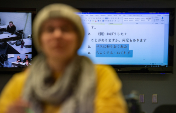 a student sits in front of a screen with information displayed