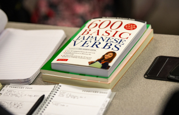 a book with the title "600 basic Japanese verbs" sits on the table