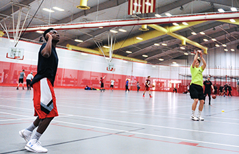 Students play basketball during open recreation