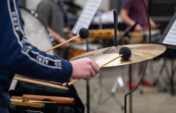 a student plays a percussion instrument