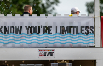 A white sign with black text says "Know You're Limitless"