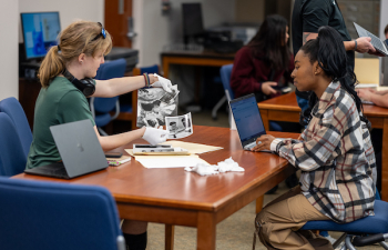 Students looking at archival photos.