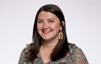 Headshot of Stephanie Kaminski, a young woman with mid length brown hair, wearing a patterned blouse