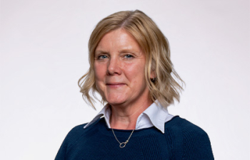 Headshot of Stephanie Shipp, a middle aged woman with short blonde hair wearing a blue collared sweater