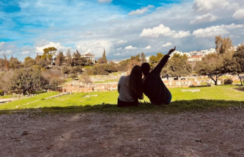 Students linking arms while overlooking a castle