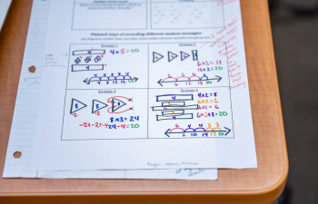 a piece of paper on a desk says "computational mathematics"
