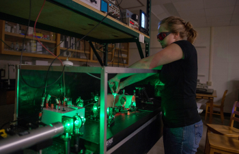 a student adjusts a laser 