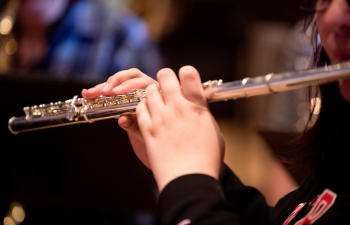 a close up shot of someone playing the flute