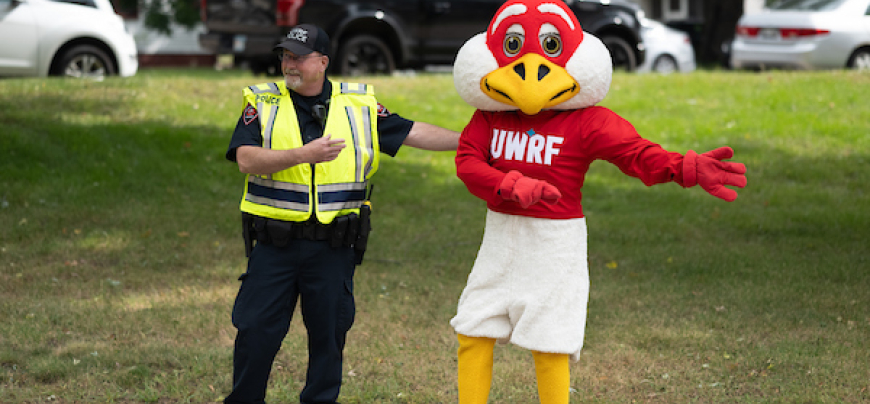 Police officer and Freddy Falcon directing traffic