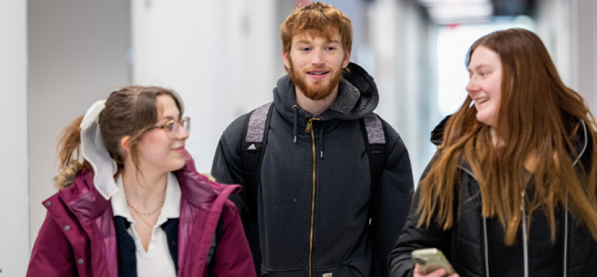 Two female and one male student walk to their classroom in SciTech on the first day of classes